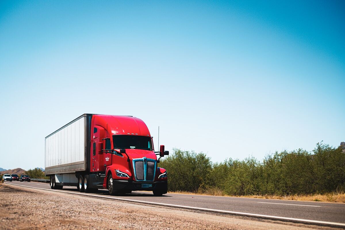 Red semi truck on country road